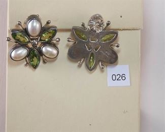 The Dreamer Sterling pierced friction post earrings measuring 11/4” across and contains 3 oval fresh water pearls, cut in half and bezel set with 3 marquise shape faceted pearls also bezel set. Sterling silver plaque holds all the pieces in place.