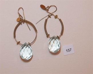 Eat wire gold Tone. Each drop earring measures approx. 2 3/8” in length. Earwire is attached to an oval wire partially covered wire a wire coil on each side of 4 bead Rondells. Suspended from the wire is a fully faceted, clear light blue Brooke ttr measuring approx. 15mm in diameter.