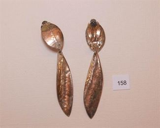 Celine Jeanne Clip back Silver Tone. Each Drop earring measures approx. 27/8” in length. The top portion is a leaf form with light line marks. The drop portion is hammered, slightly twisted, leaf shape.