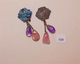 Pierced earwire silver tone. Each drop earring measures approx. 1 7/8” in length. One earring stamped with Chinese characters on the back top portion.  The top priority oration has enameling in turquoise and dark blue. Two drops are smooth polished stones - rise quartz and amethyst.