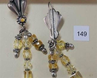 Pierced earwire stamped “925” SS. Each drop earring measures approx. 2 5/8” in length. The top portion is a triple flute design ending with a small yellow cabochon, bezel set, surrounded by small silver beads. Three drops include arrangements of clear yellow, faceted beads, and silver rondels.