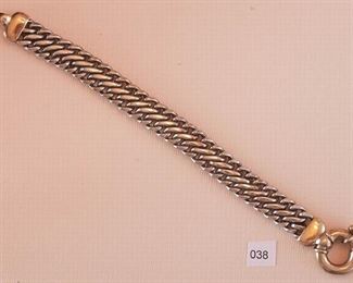 Sterling, marked 925, and probably vermeil link bracelets measures approximately 7 3/4” in length. The central sterling link portion measures approximately 1/2” in width and 6 1/4” in length. Both ends of the clasp are sterling silver/vermeil. The large spring measures approximately 13/16” in diameter.