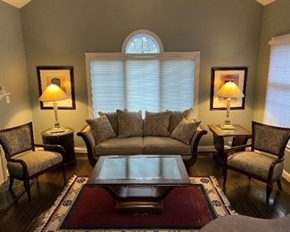 Schnadig Rolled arm wooden accent linen upholstered sofa, Schnadig harp shaped glass top coffee table, Schnadig curved back upholstered armchairs, Schnadig harp shaped glass top end table, Schnadig mirrored top 1 door round end table