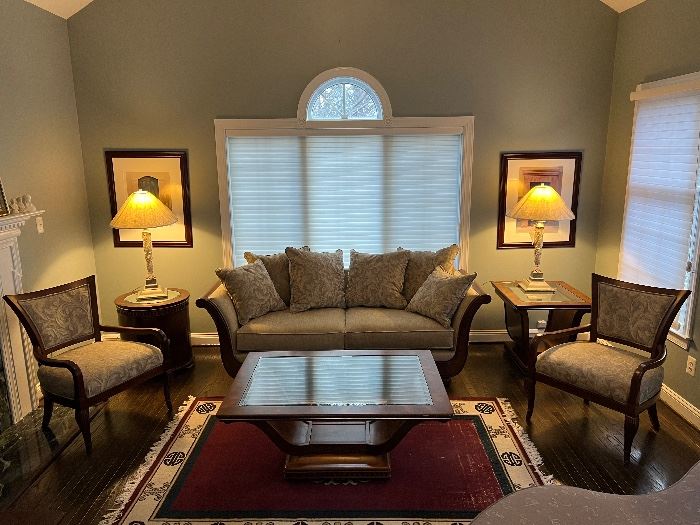 Schnadig Rolled arm wooden accent linen upholstered sofa, Schnadig harp shaped glass top coffee table, Schnadig curved back upholstered armchairs, Schnadig harp shaped glass top end table, Schnadig mirrored top 1 door round end table