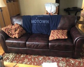 Two brown leather sofa's available with tight back and attached seats.   Both in great condition.  The rug  shown here is also for sale