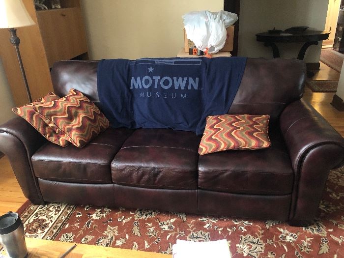Two brown leather sofa's available with tight back and attached seats. Both in great condition. The rug shown here is also for sale