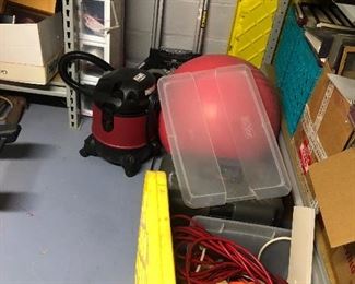 lots of items in the basement - small shop vac, electrical plugs, metal storage racks  
