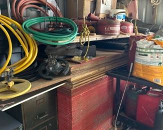 Vintage gas cans, hoses, wood, sprinklers, cart, plywood sheeting, 