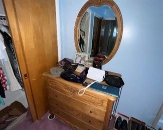 Purses and clutches along with shoes and a beautiful Oakwood interiors dresser. The complete bedroom set is available.