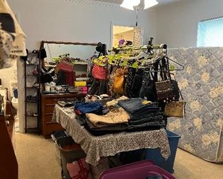 This room is FILLED with clothing, shoes, and purses!