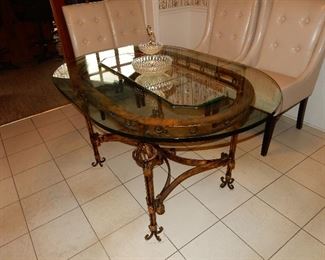 Ornate iron design oval glass table