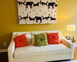 Pottery barn sofa and African wall hanging