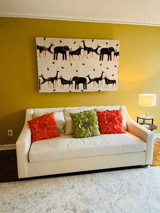 Pottery barn sofa and African wall hanging