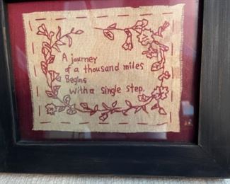 Several framed pieces of needlework