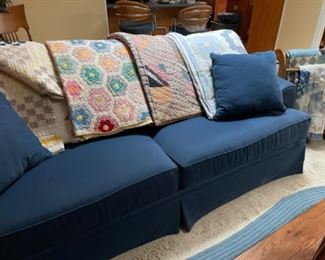 One of two navy Broyhill sofas