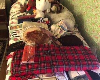 Bolt of wool plaid fabric, hand carved mahogany twin beds