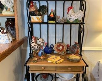 this baker's rack holds part of the rooster collection found in this sale. some of the roosters are also cookie jars.