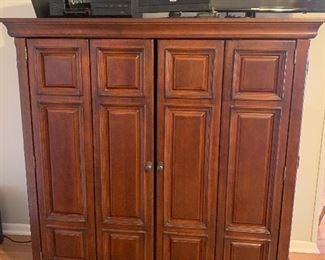 The television entertainment center is 58" wide and tall, and 19"deep. It has fold -away doors.