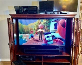 This is the entertainment center open with its doors folded back featuring the 55"Toshiba flat screen television.  The color is amazing on this set.