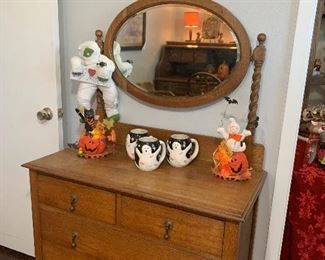 This antique 4 drawer chest has an attached beveled mirror.