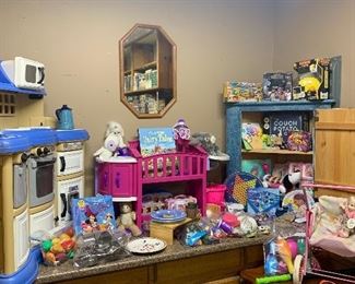 The garage has a children's corner. Notice the child's toy stove and the child's toy crib. 