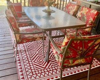 There are 2 identical rugs- both in great shape. The outdoor table and 6 chairs are in great condition. There is some fading but there is still a lot of life left in them.