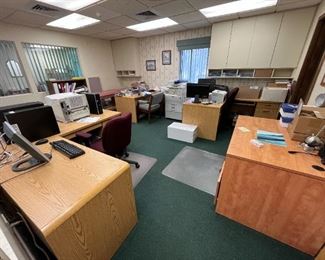 Many desks and office chairs