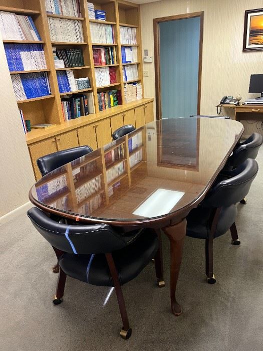 Glass top conference table $250,  Would also make a nice, large dining table.  8 navy leather rolling chairs are SOLD.
