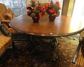 Round dining, breakfast or game table with scrolled iron base.