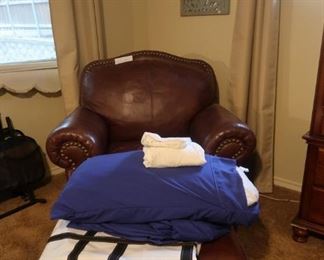 Another gorgeous, leather chair and ottoman with nailhead trim.
