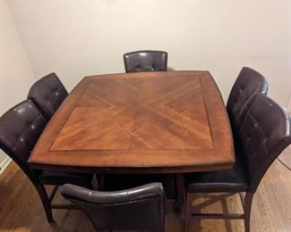 Nice family table with 6 chairs and a built in wine rack.
