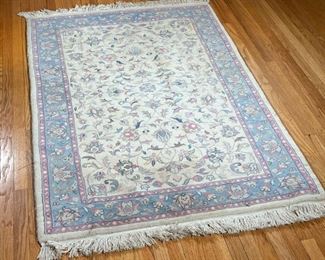 SMALL FLORAL RUG  |  Floral rug with tan field and blue and pink border - l. 71 x w. 47 in.
