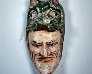 CARVED ASIAN MASK  |  Polychrome wood carved mask of man wearing head of an animal - l. 8 x w. 8 x h. 17 in.