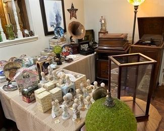 Looking at the collection of Precious Moments, collector plates, Mid-Century Spaghetti light fixture, doll display case