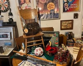 Oak pedestal table with leaf and 6 pressed back chairs in the game room. 