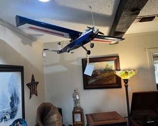 Vintage remote control airplane hanging in the living room.