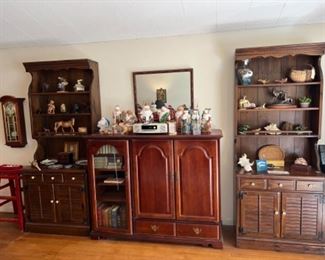 Living room with pair bookshelves, entertainment cabinet , vintage Carved Russian Santas, seashells, classic books