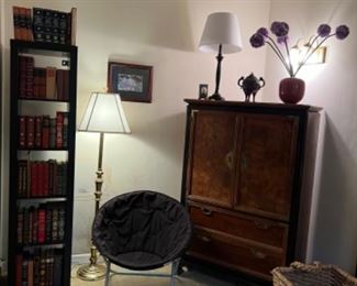 Tall skinny whatnot shelf, Asian design gentlemen chest, mcm moon chair, leather with gold classics, large wicker rope basket