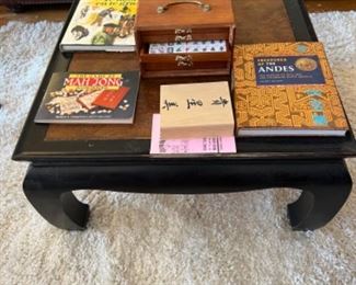 Books, mahjong, white shag carpet, asian coffee table