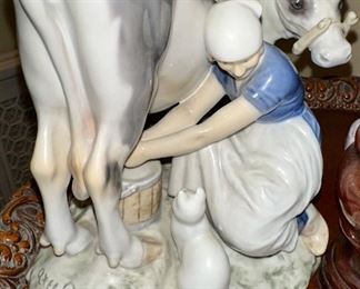 Milkmaid milking a cow while the cat looks on, Bing & Grondahl figurine