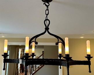 Hand forged Chandelier, made and purchased in France 1950's with glass shades on the bulbs