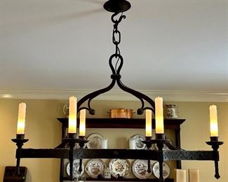 Hand forged Chandelier, made and purchased in France 1950's with glass shades on the bulbs