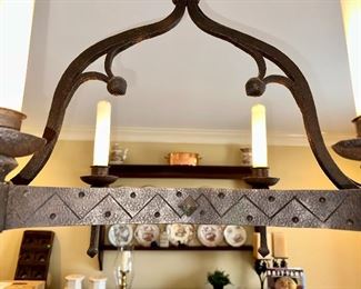 Hand forged Chandelier, made and purchased in France 1950's with glass shades on the bulbs