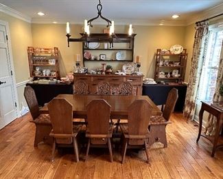 This dining set was purchased in the early 1950s by our homeowner's in-laws. It was hand carved in Brittany, France by master carpenters.  Truly unique and a show-stopper!  The seats are woven in leather! The chandelier above the table is also available. 