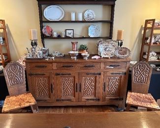 This dining set was purchased in the early 1950s by our homeowner's in-laws. It was hand carved in Brittany, France by master carpenters.  Truly unique and a show-stopper!  The seats are woven in leather! 