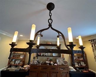 Hand forged Chandelier, made and purchased in France 1950's with glass shades on the bulbs
