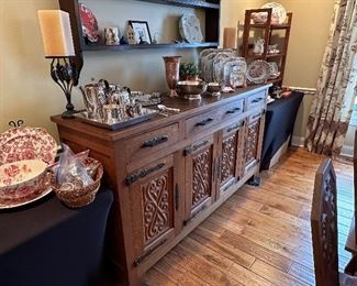 This dining set was purchased in the early 1950s by our homeowner's in-laws. It was hand carved in Brittany, France by master carpenters.  Truly unique and a show-stopper!  The seats are woven in leather! 