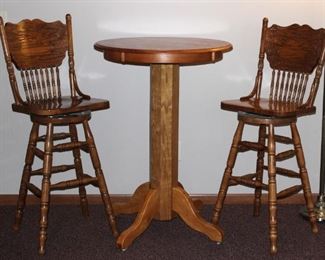Oak high Pub/Bar table with two swivel chairs.
