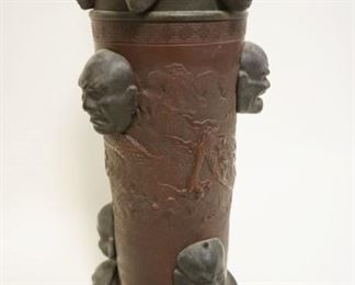 1036	UNUSUAL ASIAN MIXED METAL CYLINDER VASE/LAMP W/APPLIED MASK FACES ALL AROUND, SOME W/HORNS & EMBOSSED DRAGON CIRCLING CYLINDER, APPROXIMATELY 18 IN HIGH VASE ONLY
