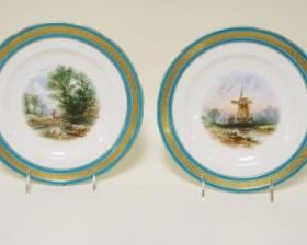 1057	LOT OF 4 HAND PAINTED DISHES W/BLUE & GILT DECORATED BORDER, SCENES OF WINDMILLS & STREAMS, APPROXIMATELY 9 1/4 IN
